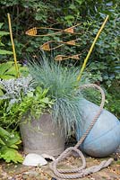 Decorative will fish in garden with container and buoy 