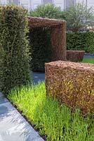 Stockton Drilling as Nature Intended Garden, Silver gilt medal winner, Chelsea Flower Show 2013. Woven willow sculptures flint path and yew hedging. 