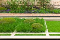 A sunken garden with Buxus sempervirens and grasses in The Brewin Dolphin Garden at the RHS Chelsea Flower Show