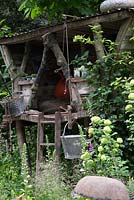 The NSPCC Garden of Magical Childhood, treehouse - galvanised buckets, Digitalis - Foxgloves, Hedera - ivy and Primula veris - cowslips