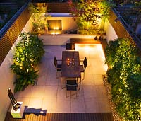 Overview of modern minimalist garden lit up at night 