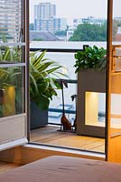 View out of an apartment to terrace with containers