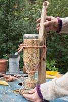 Standing Bird Feeder upright to empty seeds into bowl
