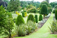 Looking over the immense formal garden studded with shaped colourful trees and topiary immaculately pruned 