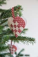 Woven heart decorations hanging on Christmas tree
