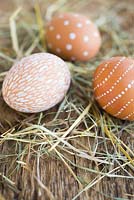 Easter display of decorated eggs on straw