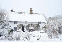 Thatched house with snow 