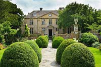 Tintinhull Court, Somerset. View of house and gardens with box topiary