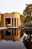 Furniture by pool in MacIntosh Garden, Morocco 