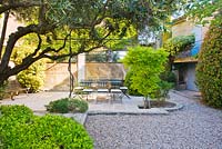 Furniture on stone paving in courtyard - A Vesian Garden, Luberon, France 