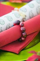 Red and green Christmas table decoration with napkin ring made of cranberries