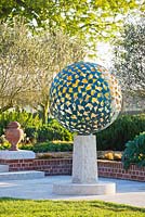 The Mantle - A verdigris bronze sphere consisting of dozens of individual bronze petals welded together 