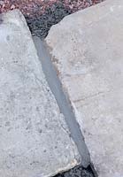 Mortar in crack between paving slabs after being smoothed down with a pointing iron