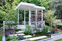 Arita, RHS Chelsea Flower Show 2014. Japanese style garden with porcelain stepping stones and outdoor shelter 
