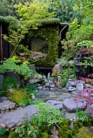 Japanese Garden with Tea house, moongate wall covered in moss and water feature. Togenkyo - A Paradise on Earth. RHS Chelsea Flower Show 2014Design Laboratory co Ltd,Ishiken Company.