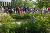 Crowds visiting the RHS Chelsea Flower Show. The Homebase Garden - 'Time to Reflect' with Alzheimer's Society. Gold medal winner