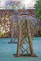 Oak tripods for climbing plants in the old garden by the back of the house 