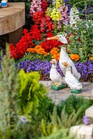 Model white ducks amongst colourful planting - The NSPCC Legacy Garden, RHS Hampton Court Flower Show 2014