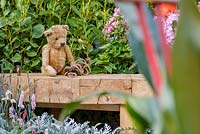 Old fashioned teddy bear and skipping rope on wooden bench - The NSPCC Legacy Garden, RHS Hampton Court Flower Show 2014