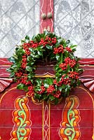 Holly wreath on door of gypsy caravan. Ilex