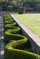 Shaped hedging and topiary at Barbara Stockitts garden at West Kington, Wiltshire