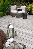 Ipe hard wood deck seating area with rattan furniture and lanterns with candles