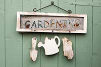 'Gardening' sign on shed door