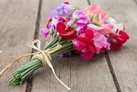 A bouquet of sweet peas on a wooden table
