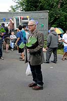 Man holding a courgette or pumpkin plant he has bought at the Alexandra Palace Allotments plant sale, London Borough of Haringey