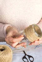 Decorating glass jars for garden posies step by step. Wrapping a glass jar with gardener's jute twine string.