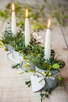 Candle holders decorated with Mistletoe, Birch hearts, Pinus and Hedera. 