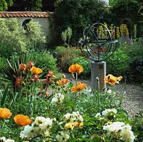 Walled, mediterranean garden with armillary sphere amidst beds of Papaver Turkish Delight, Rosa White Pet, foxtail lilies, Iris Bronze Bird and asphodeline.