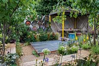 A contemporary garden created from reclaimed and salvaged materials with a covered seating area and green roof.