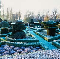 Formal, early 20th century knot garden. Yew topiary - peacocks, chess pieces and abstract shapes. Low box hedges mark parterre pattern.