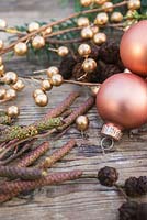 Copper colour themed Christmas decorations. Baubles, alder cones and foliage