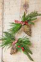 Hanging decoration of pine cones, pine foliage and hawthorn - crataegus berries