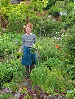 Alys Fowler, gardener, author and TV presenter, picks mint in her 18m x 6m back garden where she grows a mix of fruit, herbs, decorative flowers and vegetables in packed borders
