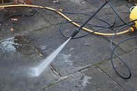 Using a Karcher high pressure jet spray to clean a patio surface