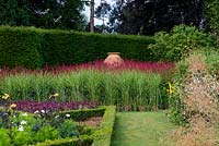 Formal box borders and mass plantings of Persicaria amplexicaulis 'Firetail' and Miscanthus 'Hinjo'. The Pool Garden at Abbeywood  