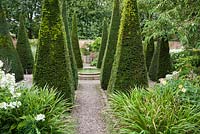 The Well Garden with central reflecting pool, tall yew spires and clipped box. Wollerton Old Hall, nr Market Drayton, Shropshire, UK