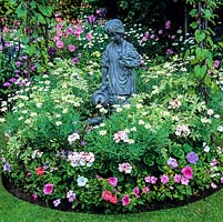 Girl water feature below arch of morning glory, in bed of marguerite, busy-lizzies, pelargonium, geranium, isotoma and petunia.