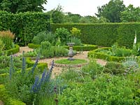 Herb Garden. Hedges planted with yew, box, teucrium, origanum. Beds: lavender, fennel, catmint, rosemary, salvia, chives, foxglove, echium, nigella, rue, feverfew. Sundial in chamomile circle.