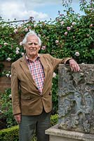Portrait of Mr David Austin OBE VMH, beside a sculpture of The Green Man, by his late wife, Mrs Pat Austin, a talented sculptor.