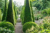 The Well Garden, Wollerton Old Hall. Yew obelisks and circular raised pool.