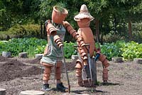 Scarecrows made from terracotta plant pots. Bablyonstoren  Cape Dutch farm vegetable garden. Nr Franschoek. South Africa