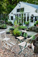 Seating, sculptural objects and plants arranged outside the shop at King John's Nursery, Etchingham, East Sussex, UK