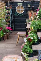 A painted garden shed and potting bench.
