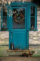 Christmas wreath on glass door to hut at Cambridge botanical gardens