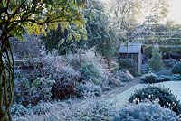 Frost covered garden, grass borders and summer house, November. St Barnabas Road, Cambridge