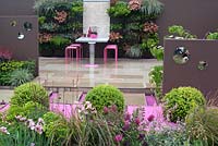 Blush, Malvern Spring Gardening Show 2014, an urban retreat using a colour scheme of browns, pinks and purple and a recurring spherical theme, with dining area and waterfall table - Designer: Pip Probert - Sponsors: Digby Stone, and David Harber 
